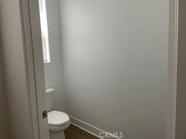 a white toilet sitting next to a shower