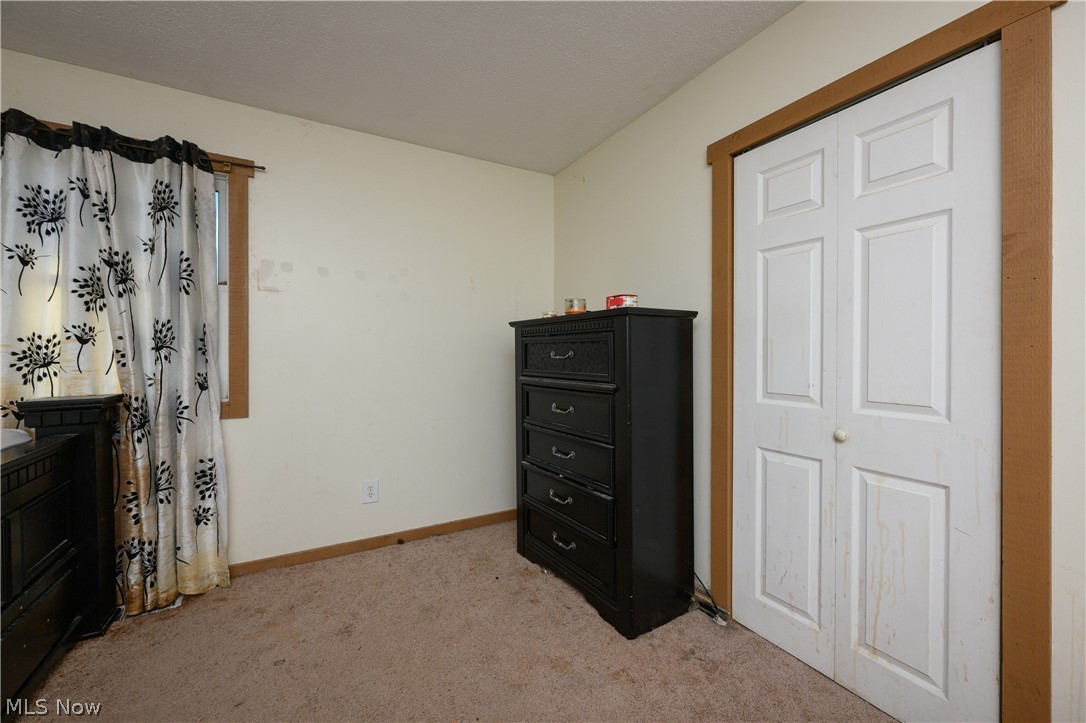 8200 Cutler Road Southwest Sherrodsville, OH 44675 - Photo 19 of 26 Bedroom with light colored carpet and baseboards
