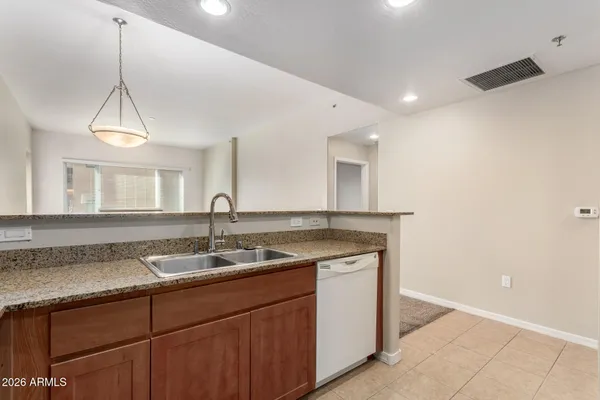 a kitchen with a sink and a mirror