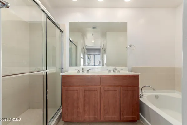 a bathroom with a bathtub sink and mirror
