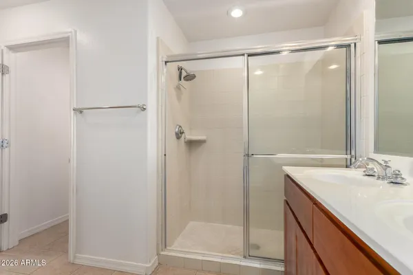 a bathroom with a shower sink and vanity