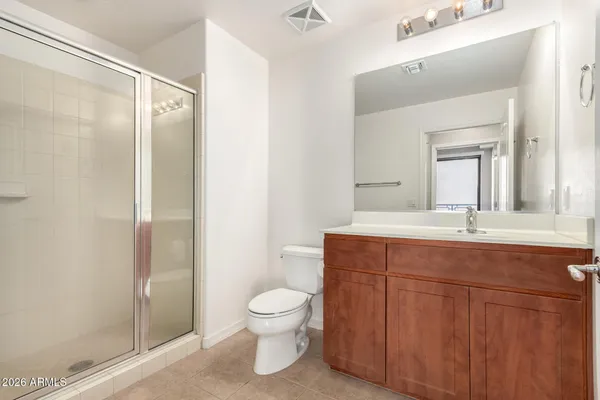 a bathroom with a toilet a sink and a mirror