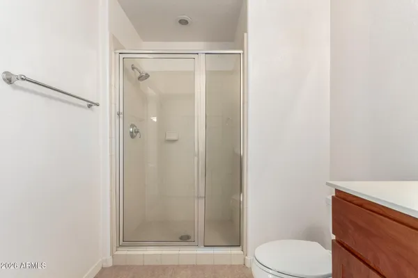 a bathroom with a shower a toilet and a sink
