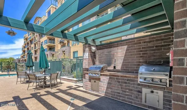 a living room with furniture a clock and a large window