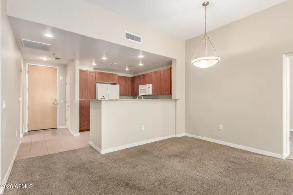 a view of a kitchen with a refrigerator and a ceiling fan