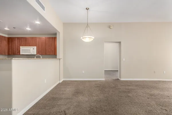 a view of a kitchen with a sink and dishwasher a refrigerator with wooden floor