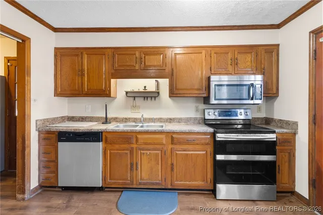 a kitchen with stainless steel appliances granite countertop a stove and a microwave