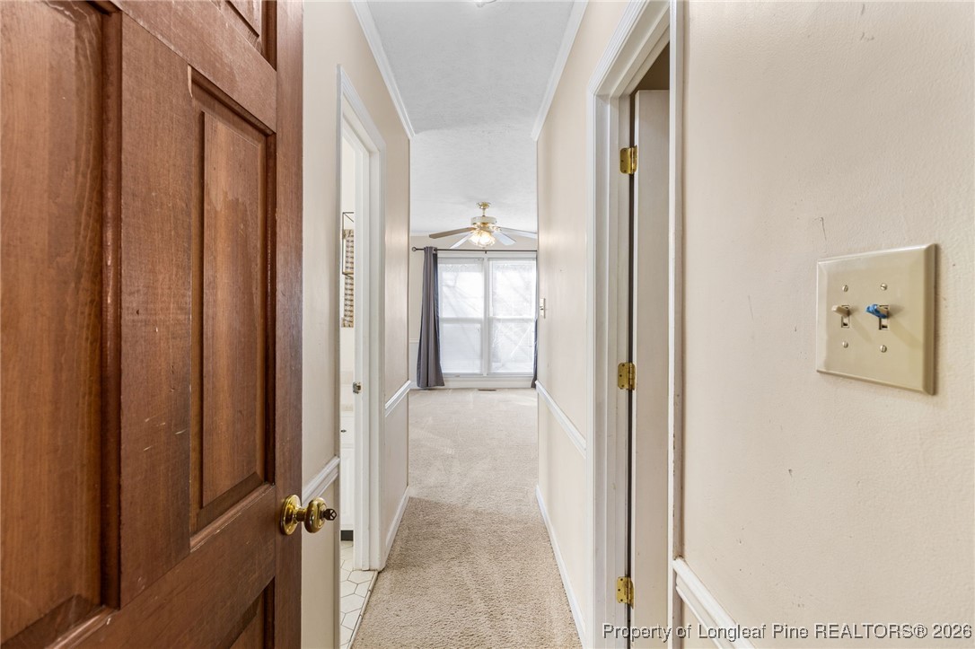 2924 Walden Road Fayetteville, NC 28303 - Photo 19 of 44 a view of a hallway with wooden shelves