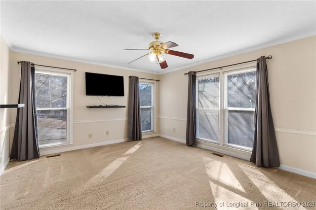 a view of a livingroom with a chandelier fan and closet