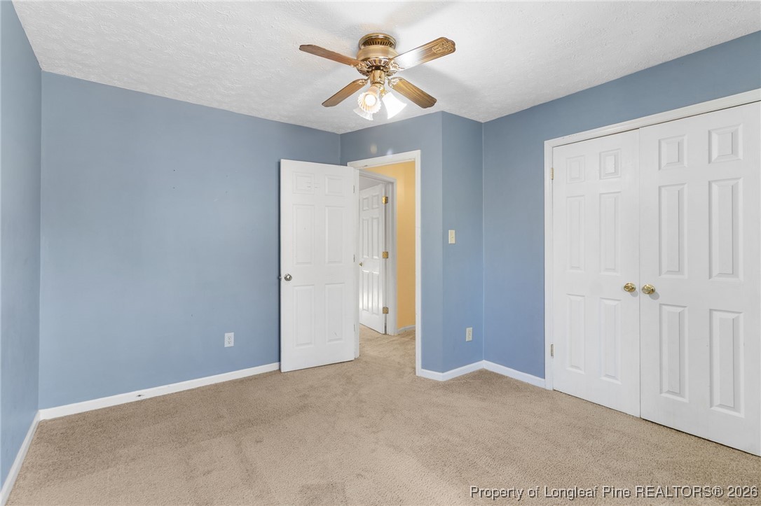 2924 Walden Road Fayetteville, NC 28303 - Photo 33 of 44 an empty room with closet and a chandelier fan