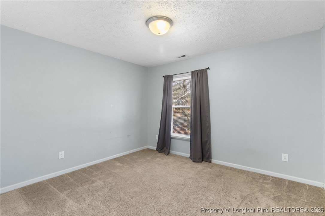 2924 Walden Road Fayetteville, NC 28303 - Photo 35 of 44 an empty room with a fan and a window