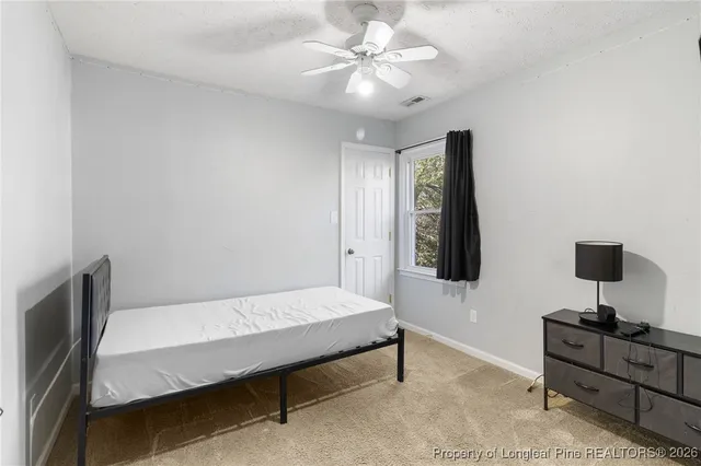 a bedroom with a bed and a desk