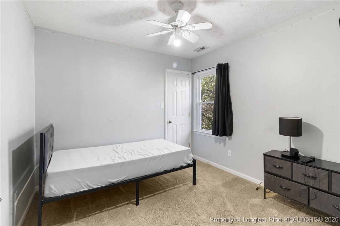 2924 Walden Road Fayetteville, NC 28303 - Photo 37 of 44 a bedroom with a bed and a desk