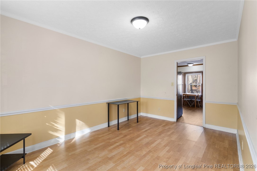 2924 Walden Road Fayetteville, NC 28303 - Photo 6 of 44 a view of an empty room with wooden floor and a window