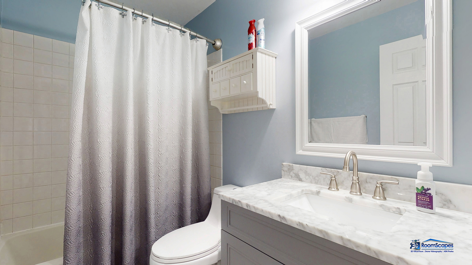 17833 Braewick Road Gurnee, IL 60031 - Photo 17 of 33 a bathroom with a sink a toilet and shower curtain