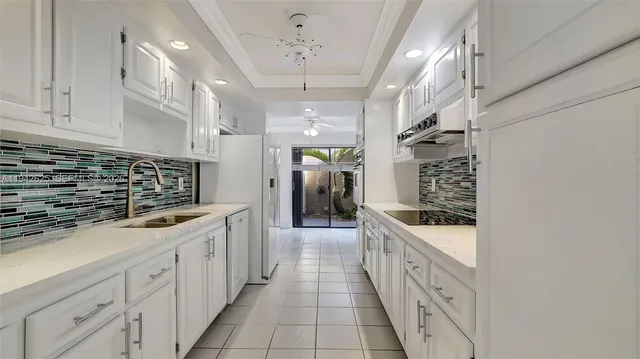 a kitchen with granite countertop cabinets and oven