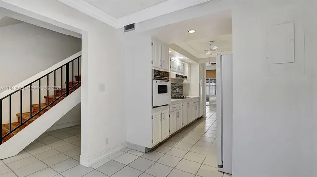 a view of a hallway with bathroom and shower
