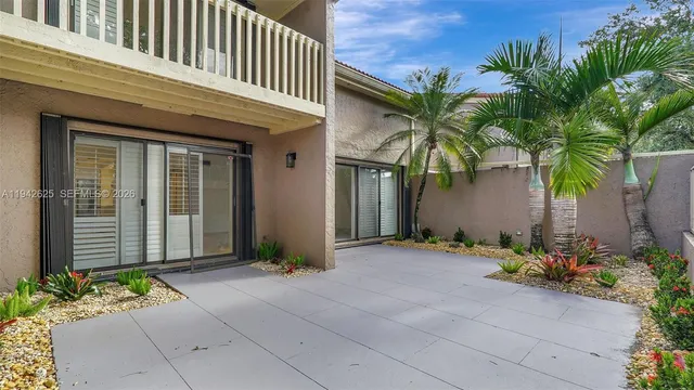 a large white kitchen with kitchen island white cabinets and wooden floor