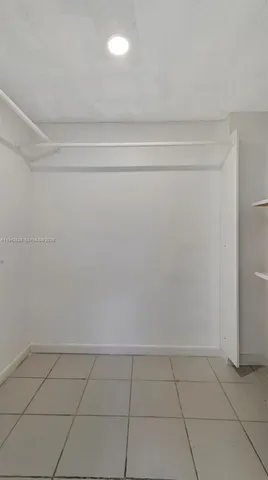 a spacious bathroom with a shower sink and mirror