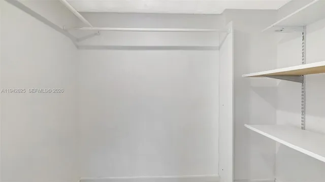 a bathroom with a tub sink shower and mirror