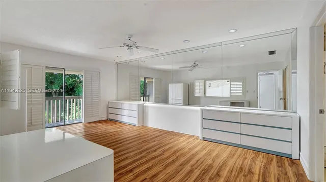 a bathroom with a sink a toilet a mirror and shower