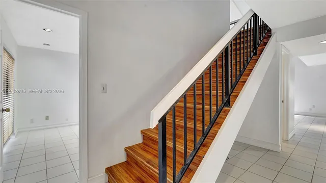 an empty room that has a large glass door and chandelier
