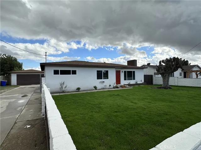 a front view of house with yard and outdoor seating