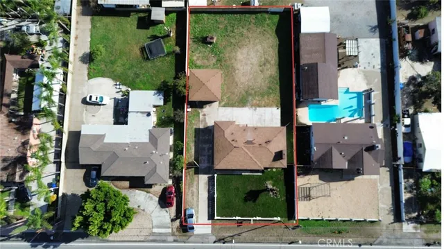 a aerial view of a house with table and chairs potted plants
