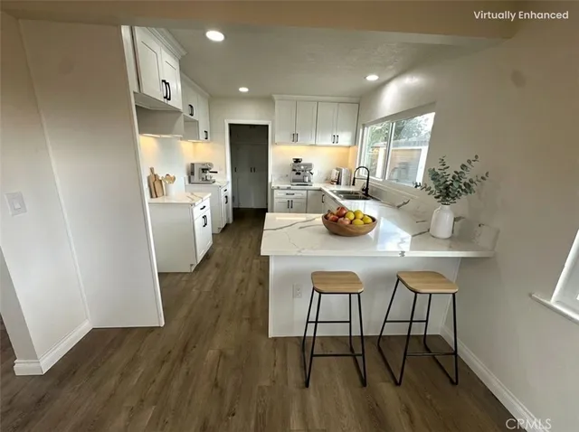 a kitchen with a table chairs refrigerator and microwave
