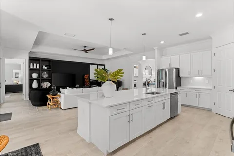 a living room with furniture and kitchen view
