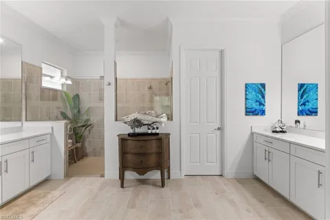 a spacious bathroom with a double vanity sink and a mirror