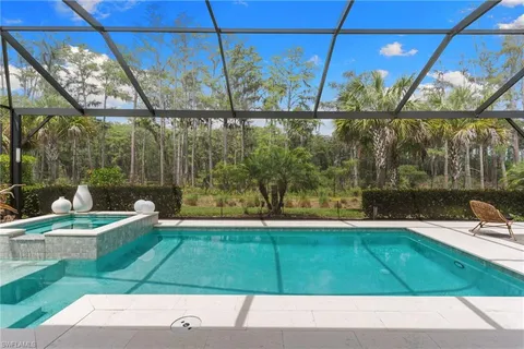 a view of a patio with a table chairs and a backyard