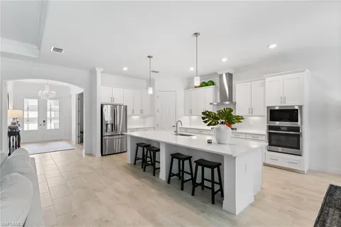 a large kitchen with a table and chairs