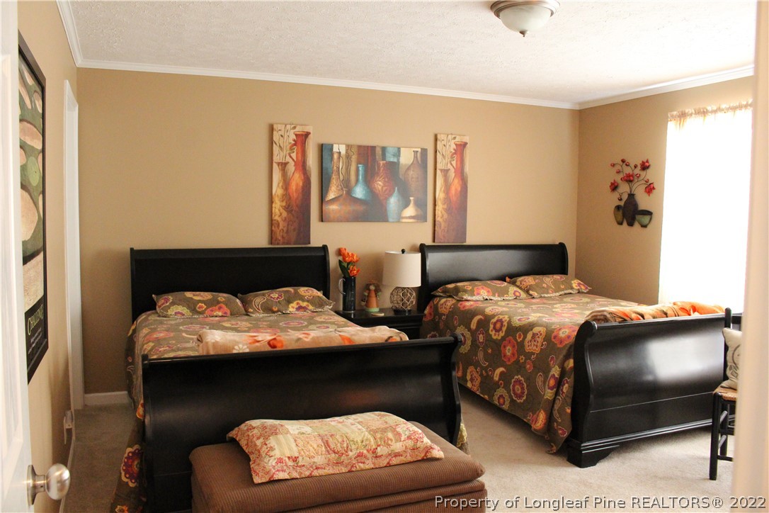 4023 Hoffman Road Jackson Springs, NC 27281 - Photo 16 of 22 a bedroom with a bed and window