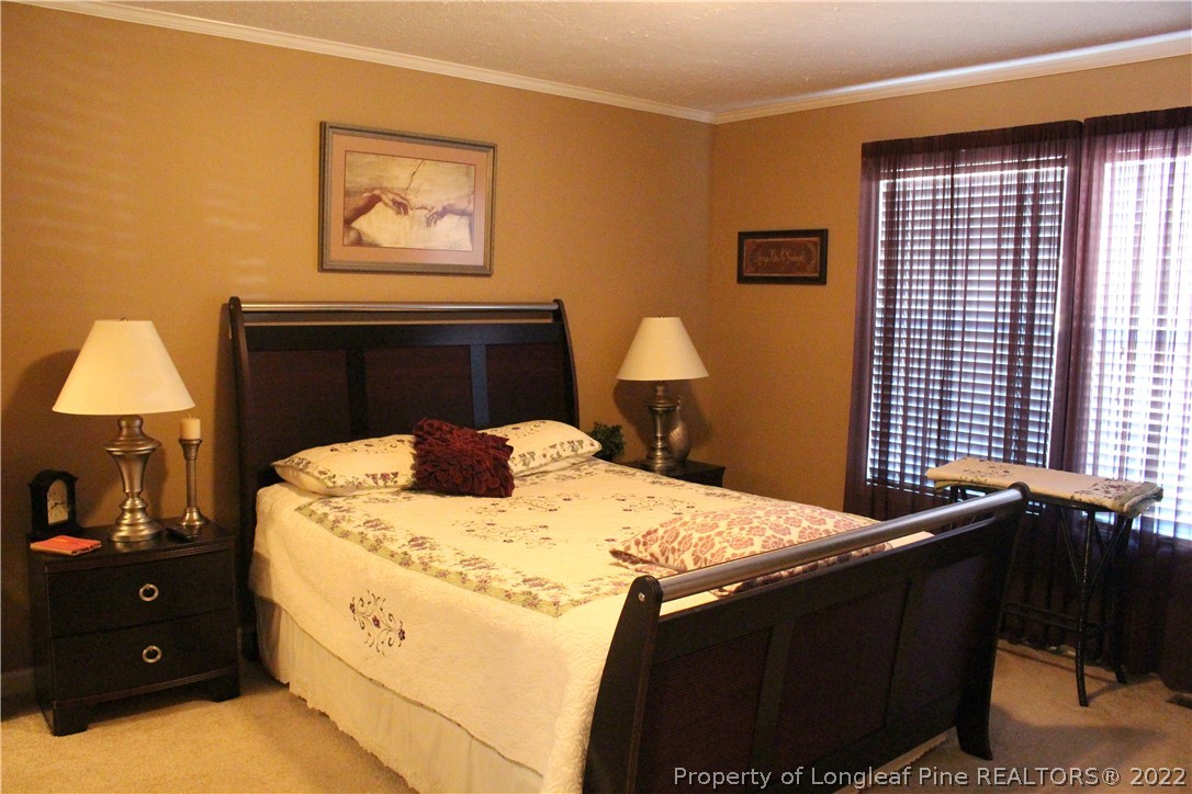 4023 Hoffman Road Jackson Springs, NC 27281 - Photo 18 of 22 a bedroom with a bed and a lamp on dresser
