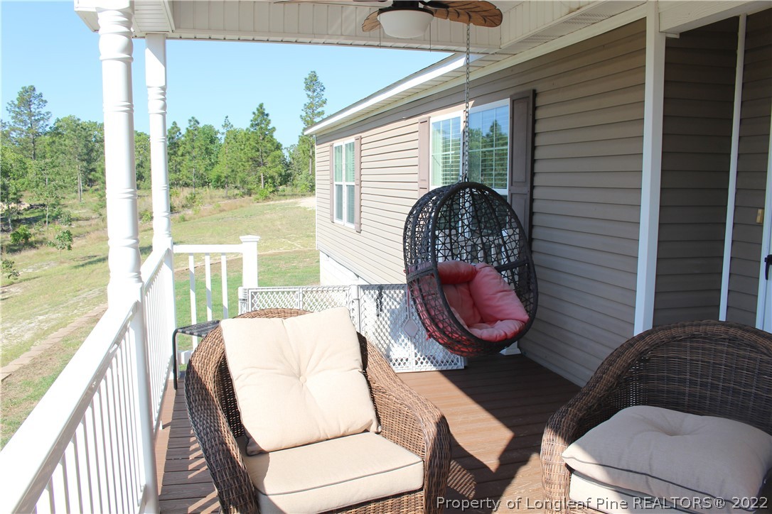 4023 Hoffman Road Jackson Springs, NC 27281 - Photo 20 of 22 a view of a balcony with a table and chairs