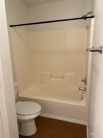 a bathroom with a shower and a toilet