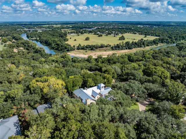 an aerial view of a houses with a yard