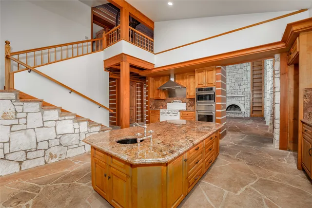 a spacious bathroom with a granite countertop sink mirror and a