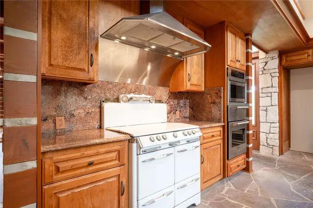a spacious bathroom with a tub and a large window