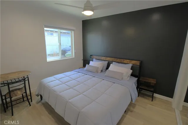 a bedroom with a bed and a window