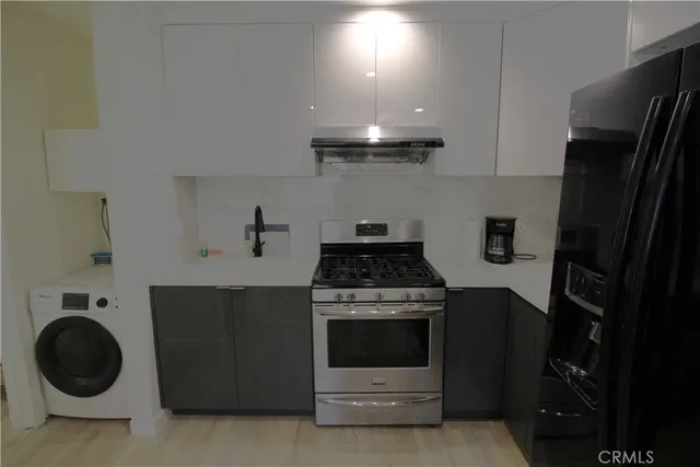 a kitchen with a stove and a refrigerator