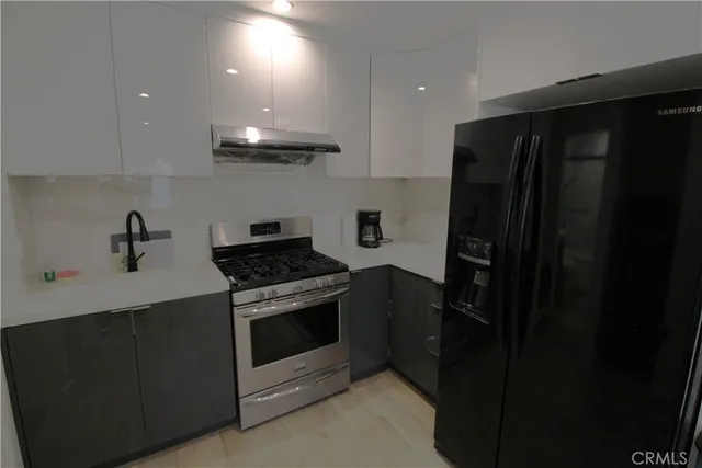 a kitchen with a stove and a refrigerator