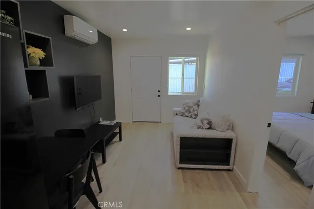 a bedroom with furniture and a flat screen tv