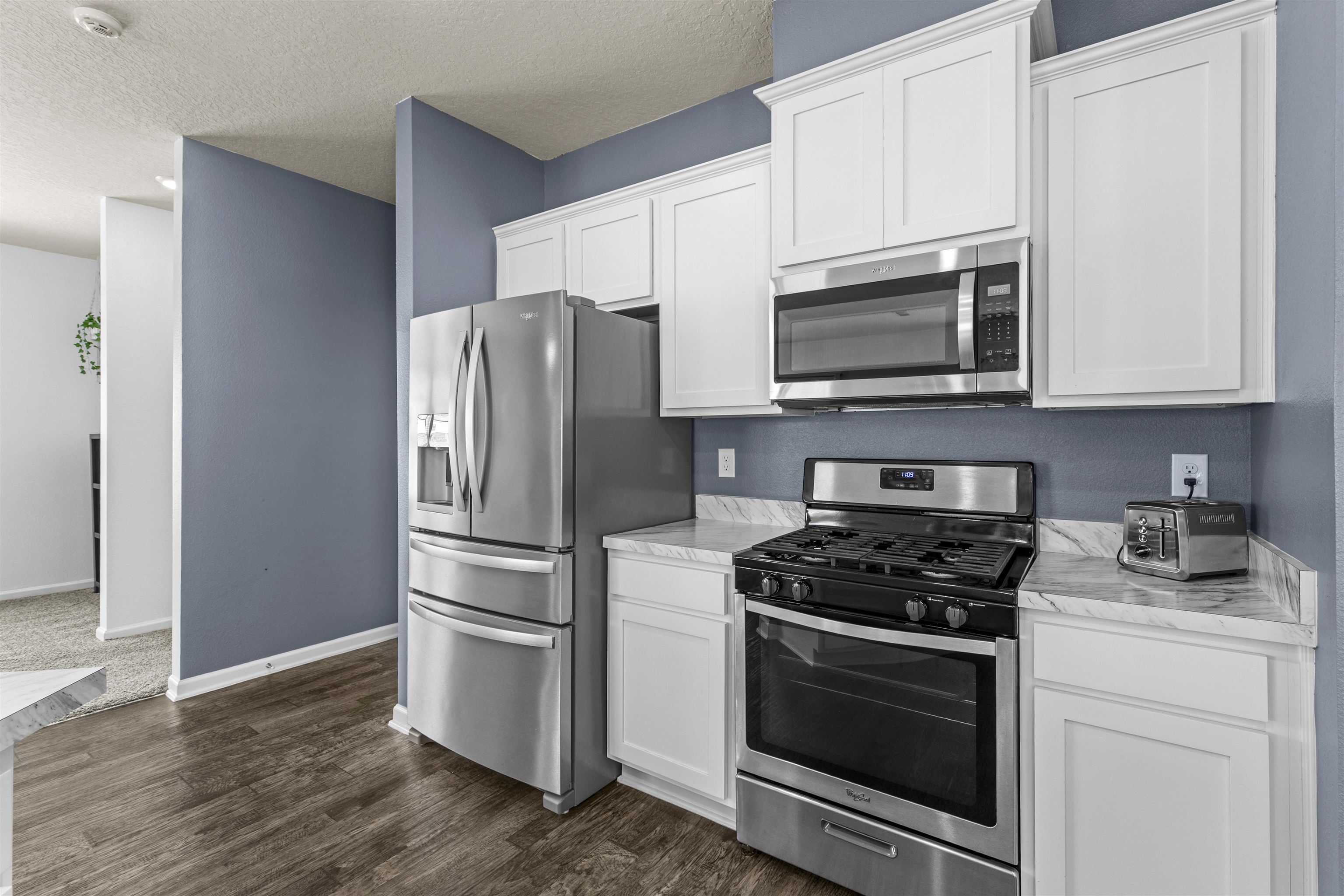 266 Caminha Road St. Augustine, FL 32084 - Photo 21 of 59 a kitchen with stainless steel appliances white cabinets a stove a microwave and a refrigerator