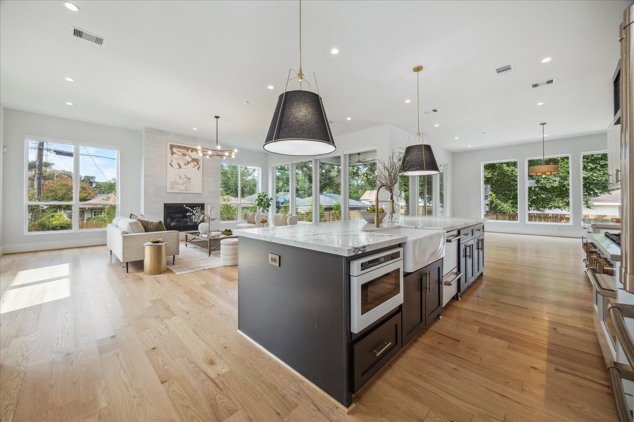 2202 Hewitt Drive Houston, TX 77018 - Photo 12 of 39 Perfect for lovers of natural light, this home’s open layout creates a spacious great-room feel, with the kitchen flowing seamlessly into the living and large dining areas.