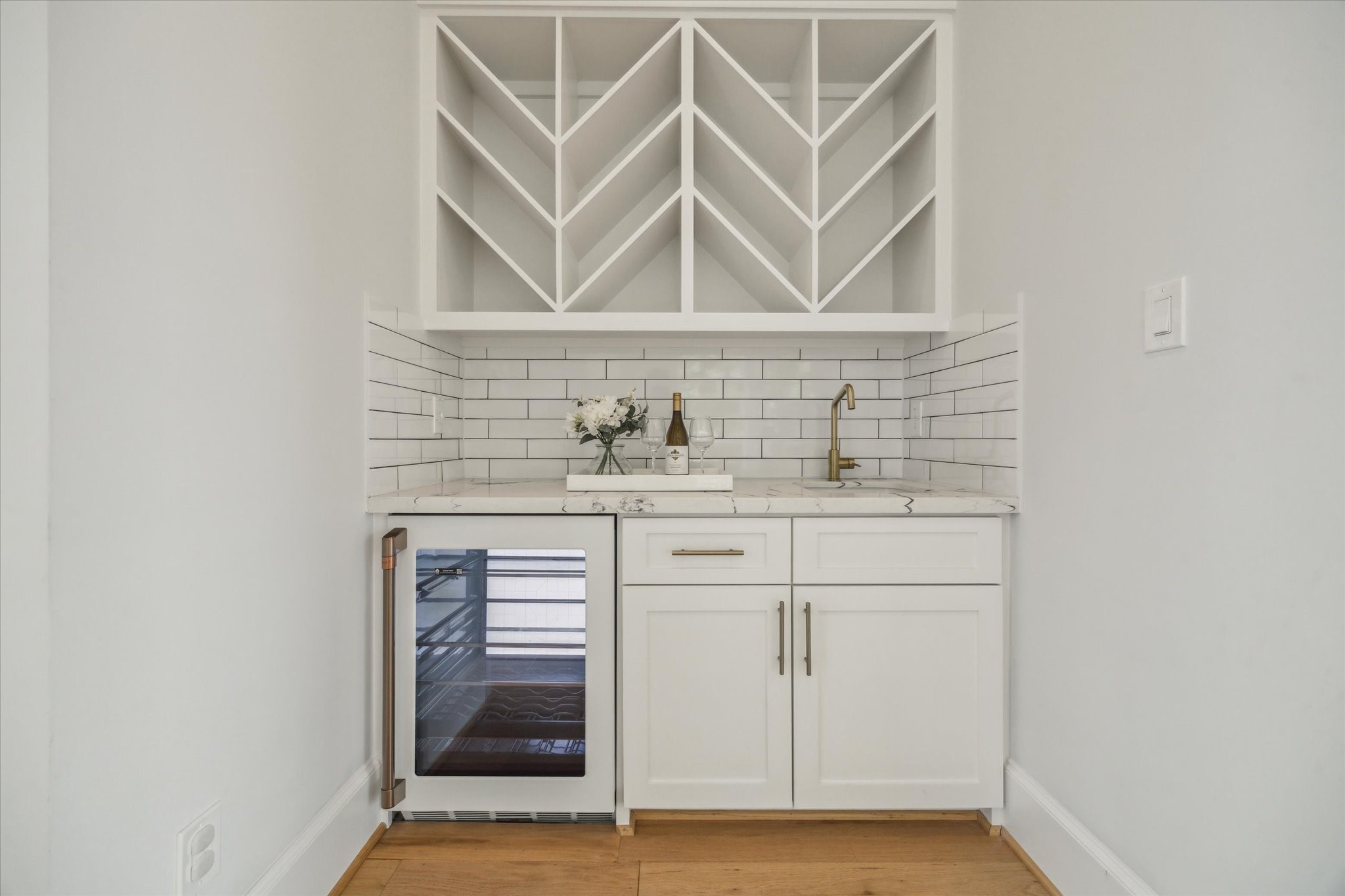 2202 Hewitt Drive Houston, TX 77018 - Photo 17 of 39 Perfectly situated between the formal living room and dining room, the wet bar offers a convenient spot for entertaining. Features include a custom wine bottle rack, bar sink, and GE Café Series beverage fridge.