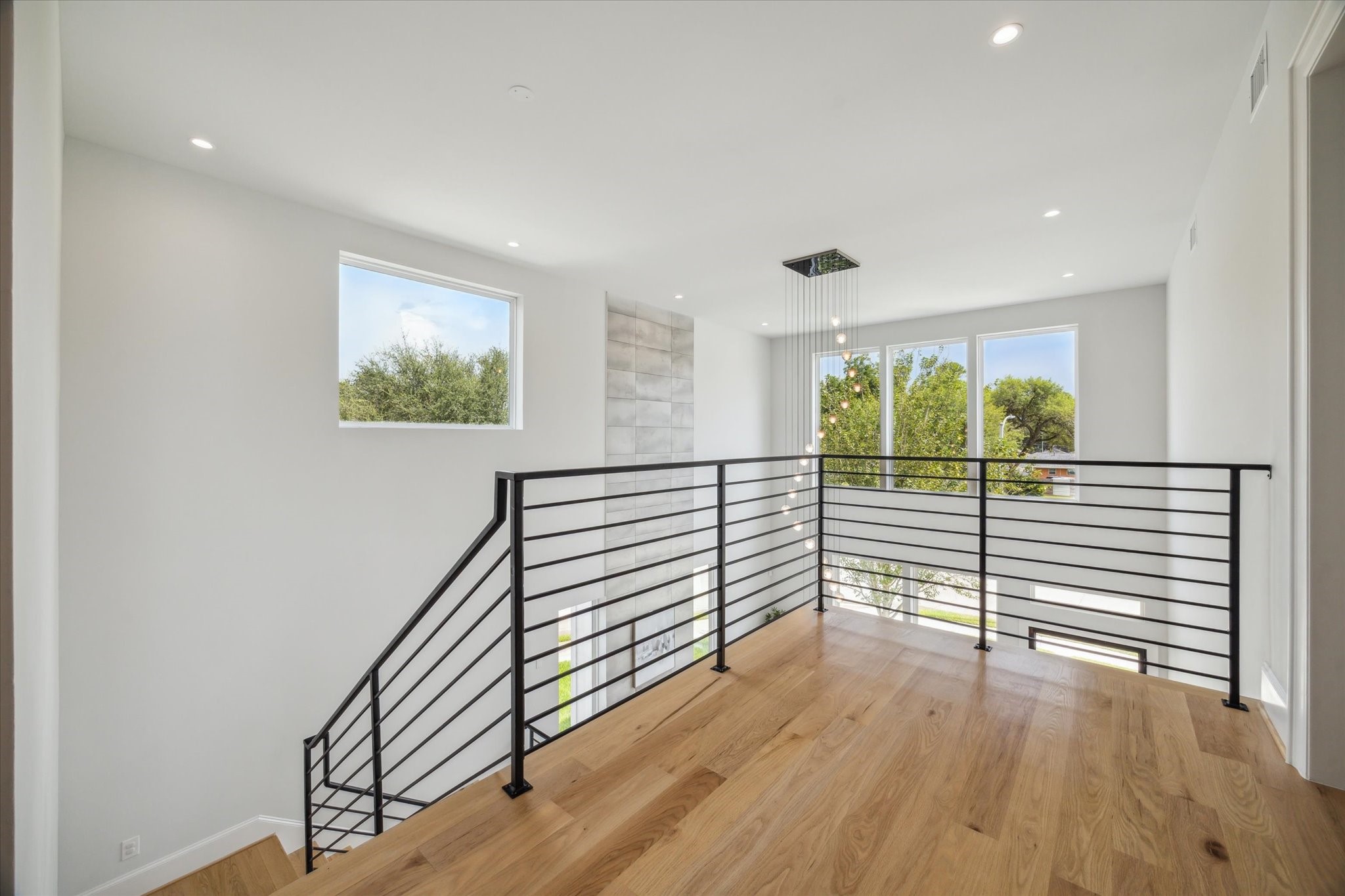 2202 Hewitt Drive Houston, TX 77018 - Photo 19 of 39 At the top of the stairs, the landing is filled with natural light, highlighting the home's bright and open feel.
