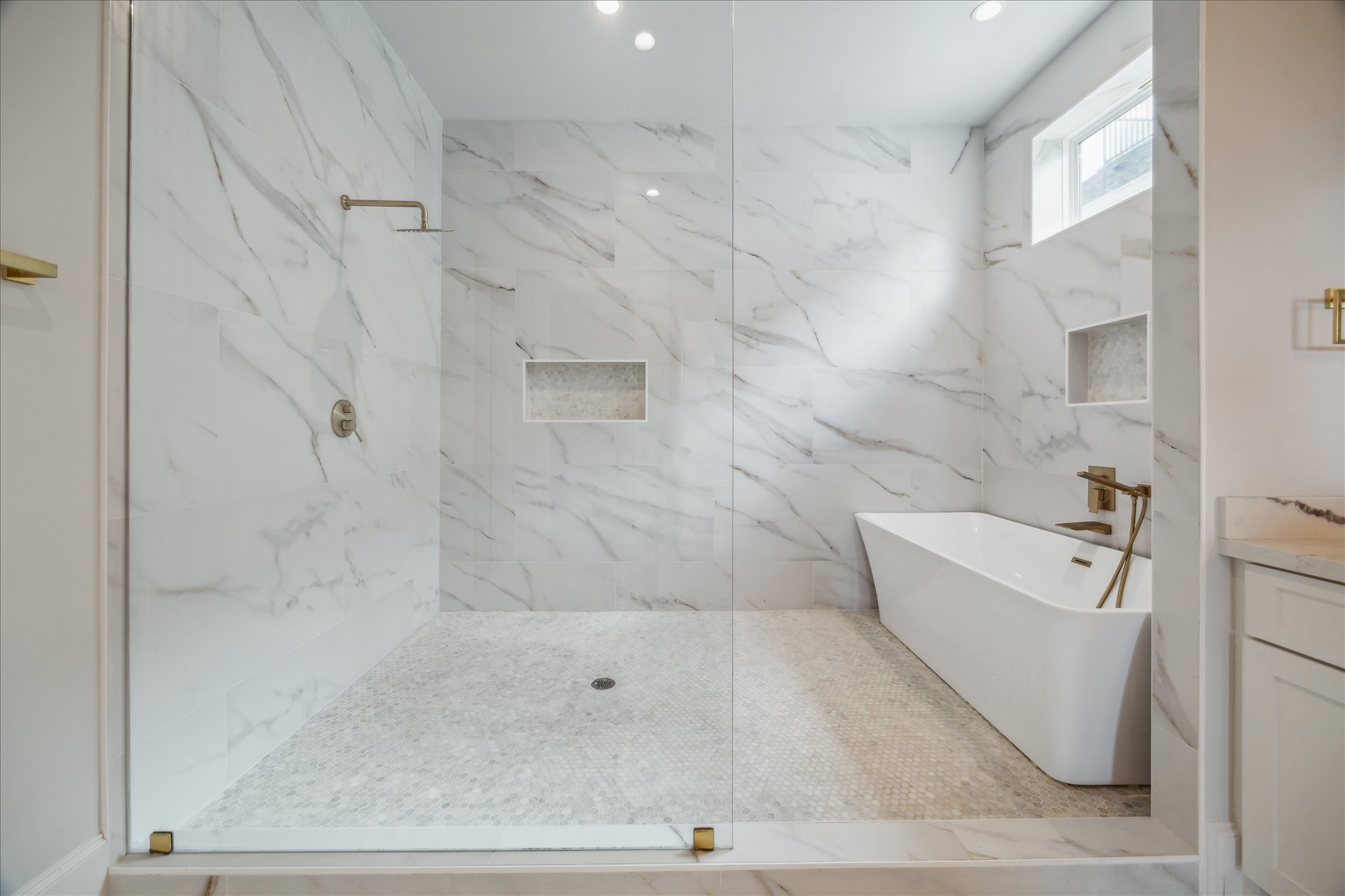 2202 Hewitt Drive Houston, TX 77018 - Photo 24 of 39 The luxurious soaking tub is enclosed within the walk-in shower area, all surrounded by a sleek glass enclosure—both stylish and functional.