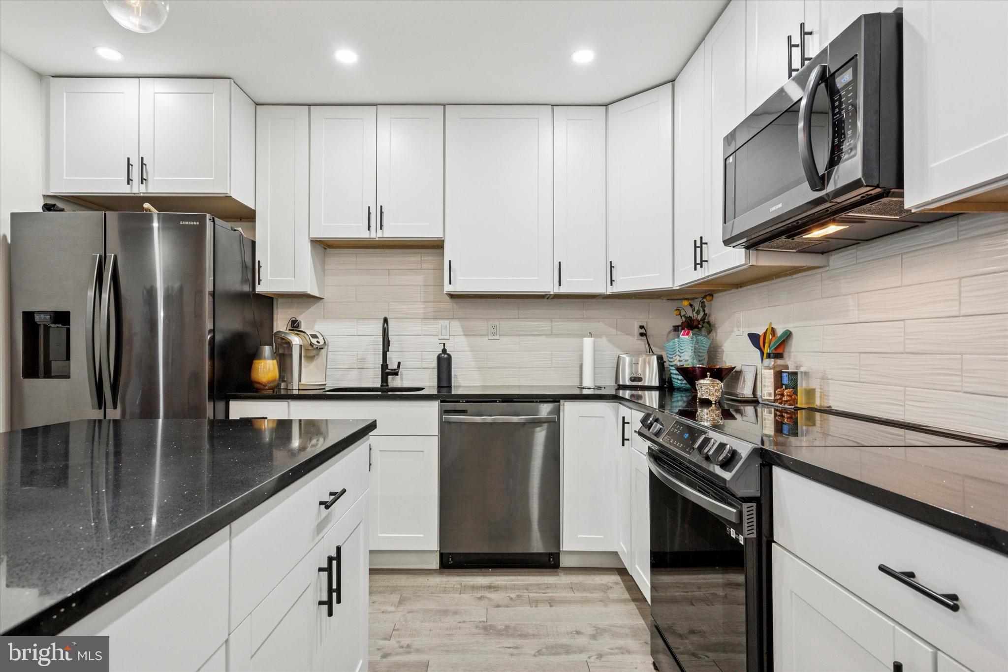 2694 Bridge Street Philadelphia, PA 19137 - Photo 27 of 41 a kitchen with kitchen island granite countertop stainless steel appliances and cabinets